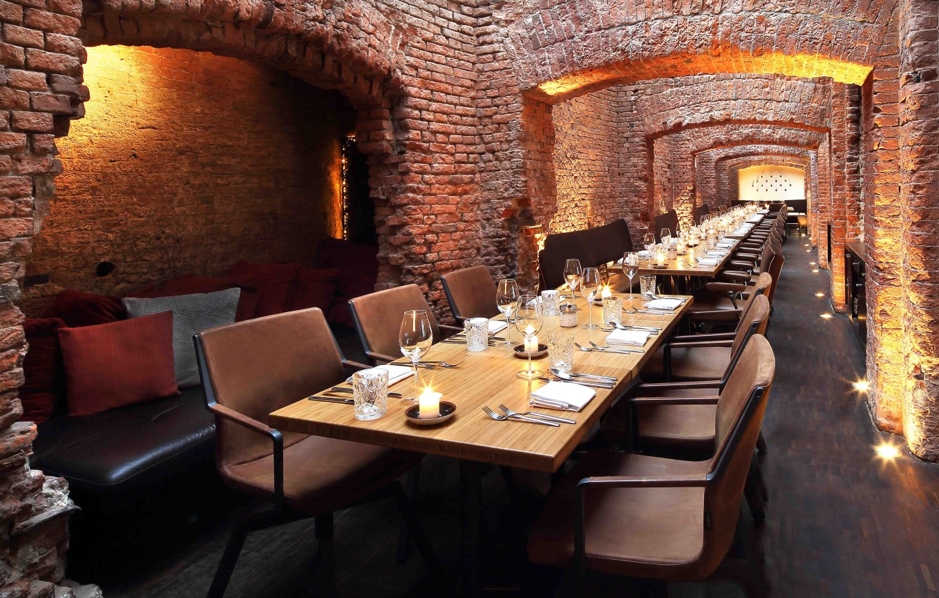 Long table in the casemates of the east restaurant by candlelight